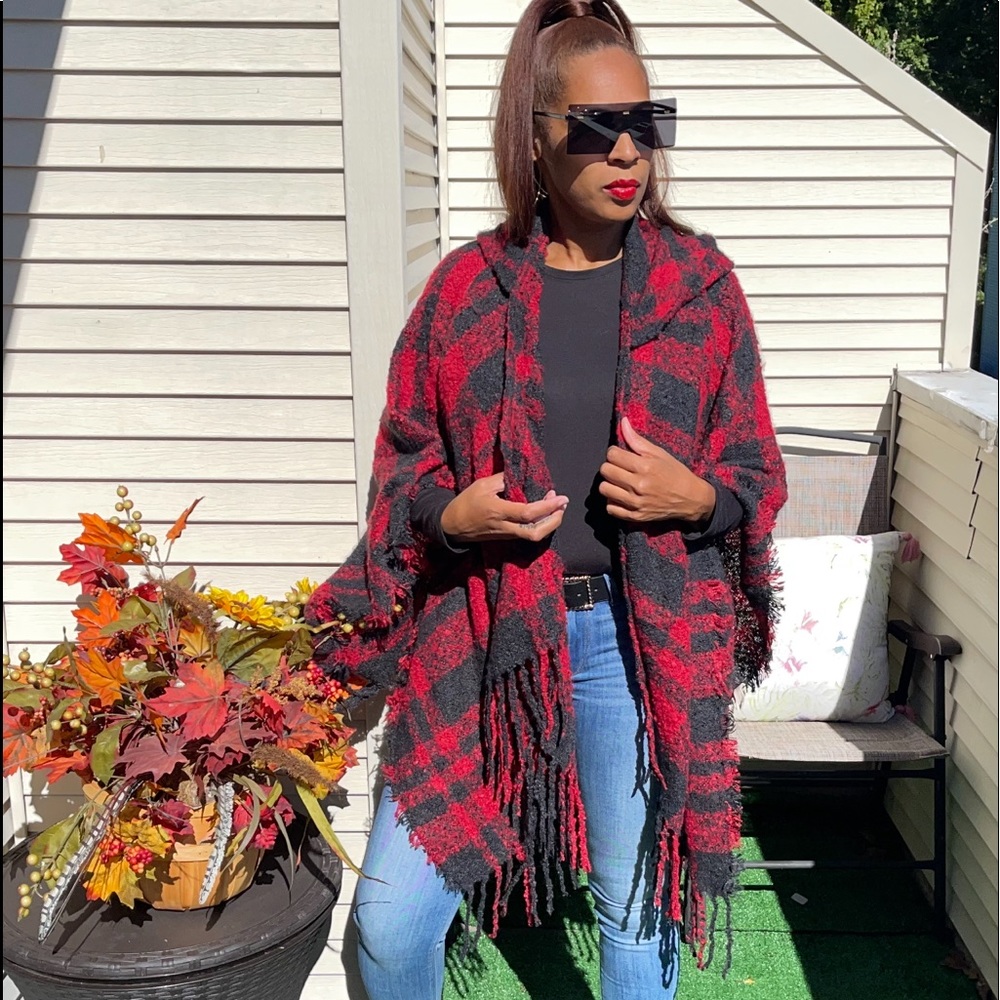 Plush soft plaid shawl features a hood.